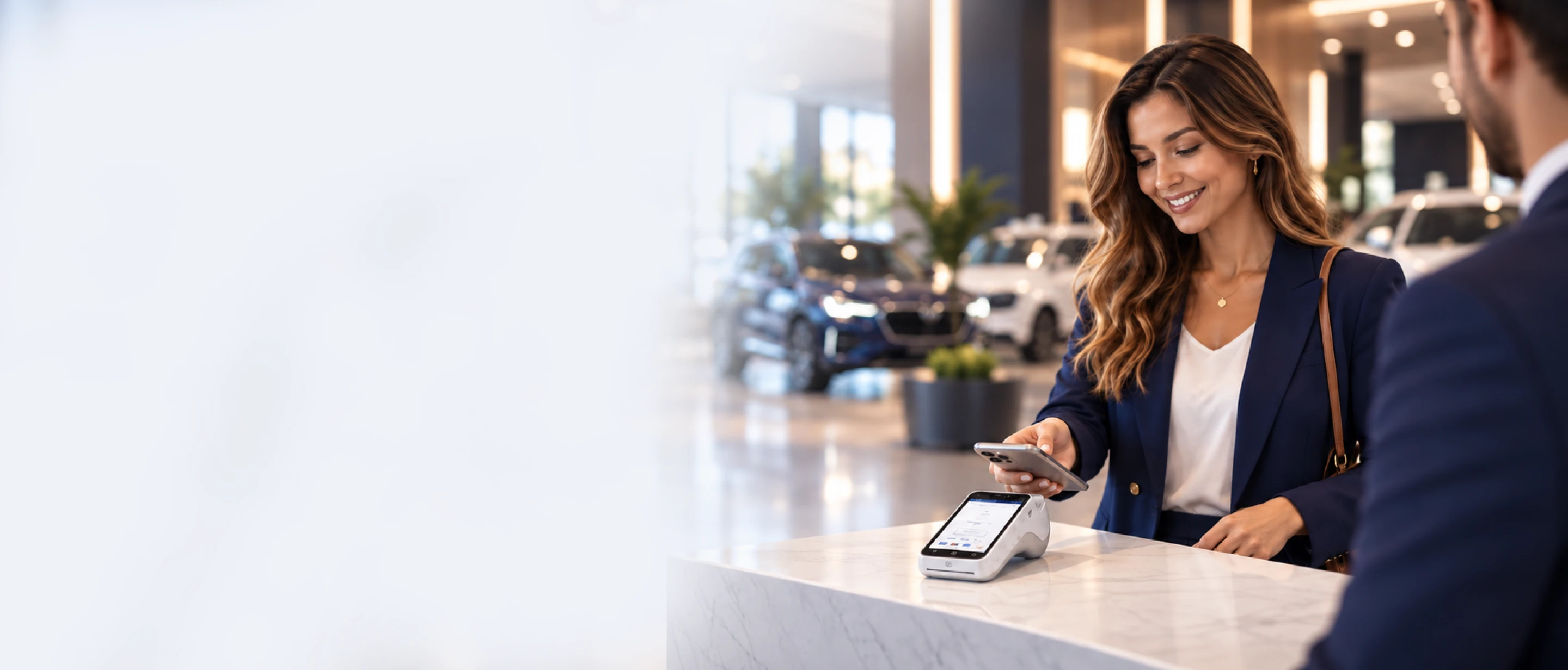 Customer making a mobile payment at a dealership